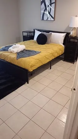 a bedroom with a bed and painting on the wall