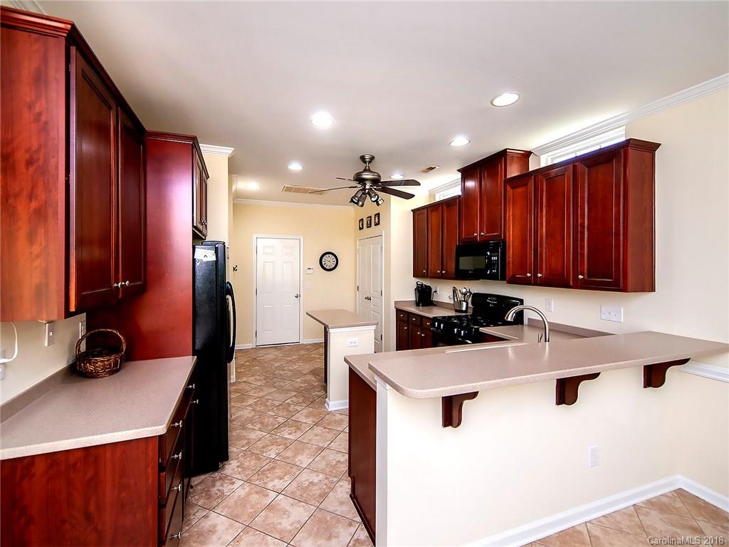 284 Sand Paver Way Fort Mill, SC 29708 - Photo 8 of 24 a kitchen with kitchen island granite countertop a sink appliances and cabinets