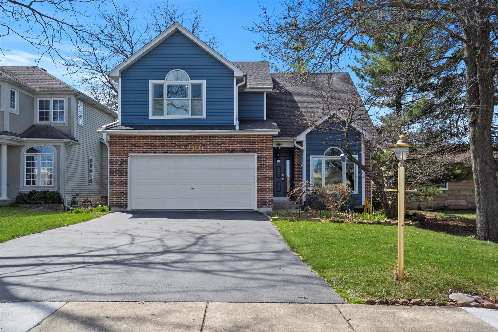 a front view of house with yard and green space