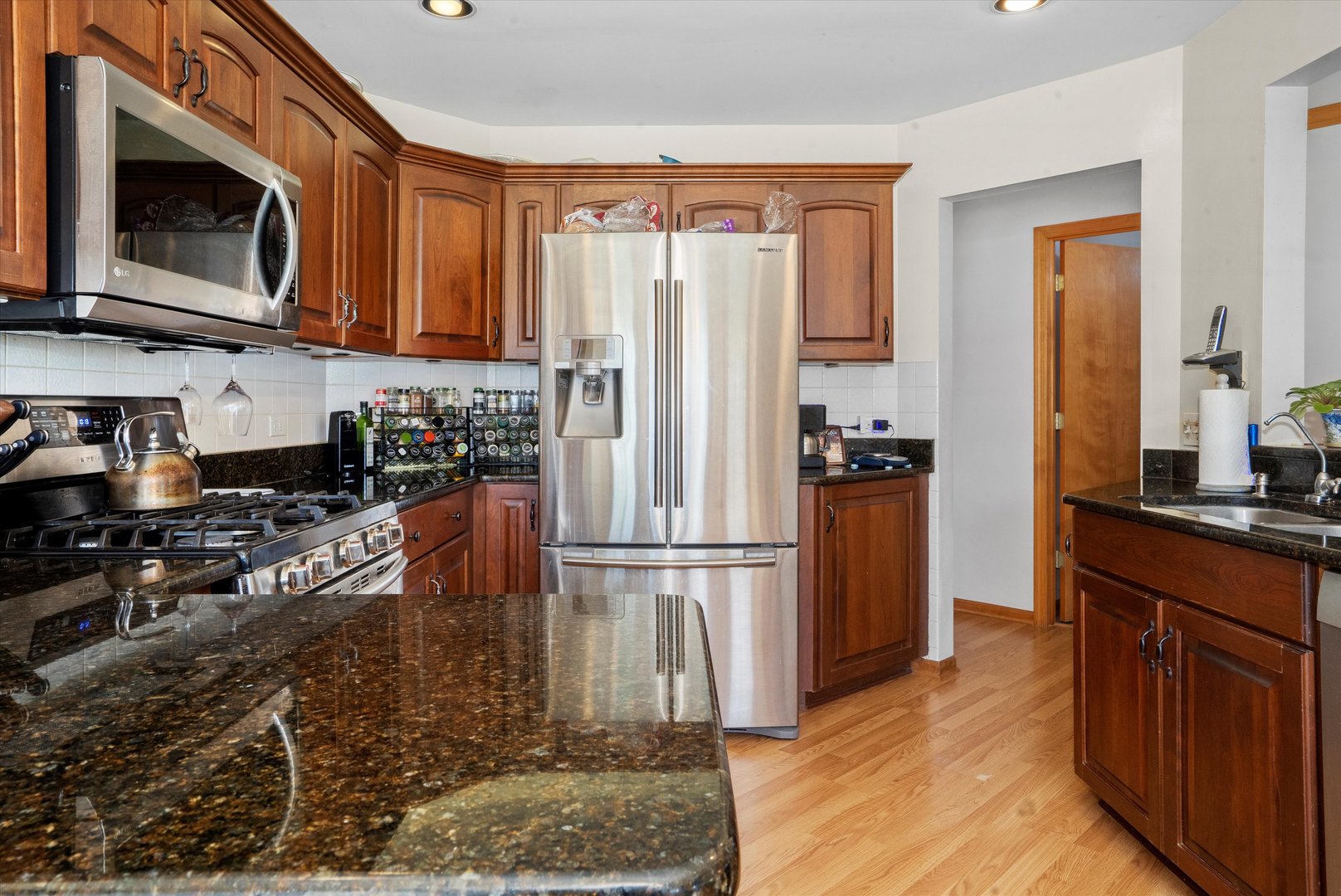 2260 Manchester Road Wheaton, IL 60187 - Photo 11 of 35 a kitchen with stainless steel appliances granite countertop a refrigerator stove top oven and sink
