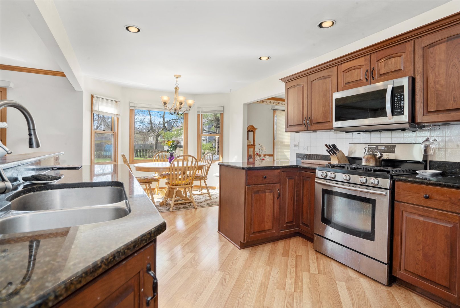 2260 Manchester Road Wheaton, IL 60187 - Photo 12 of 35 a kitchen with stainless steel appliances granite countertop a sink stove and microwave