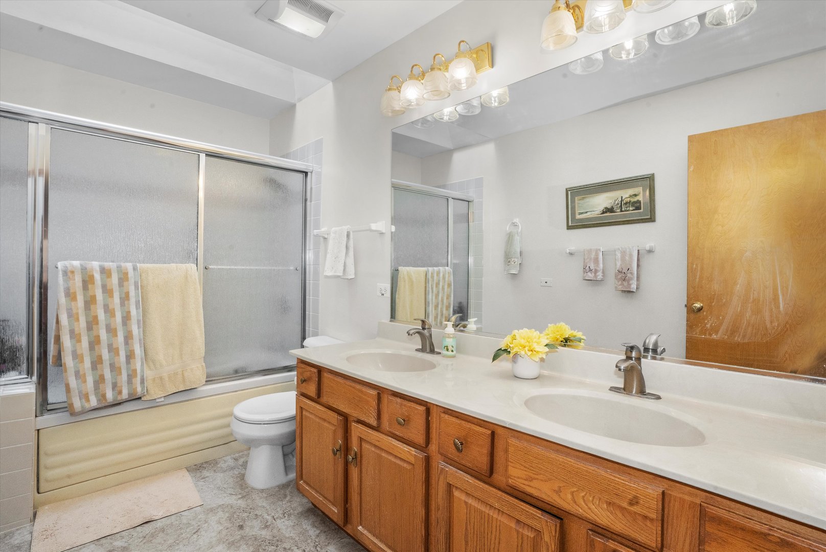 2260 Manchester Road Wheaton, IL 60187 - Photo 17 of 35 a spacious bathroom with a double vanity sink toilet and shower