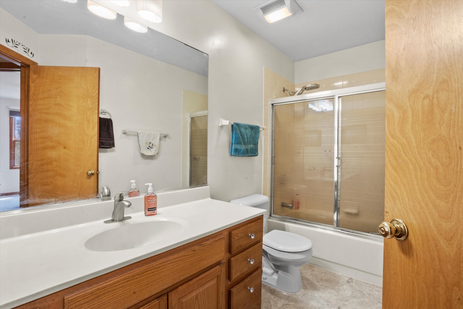 2260 Manchester Road Wheaton, IL 60187 - Photo 20 of 35 a bathroom with a granite countertop sink toilet and shower