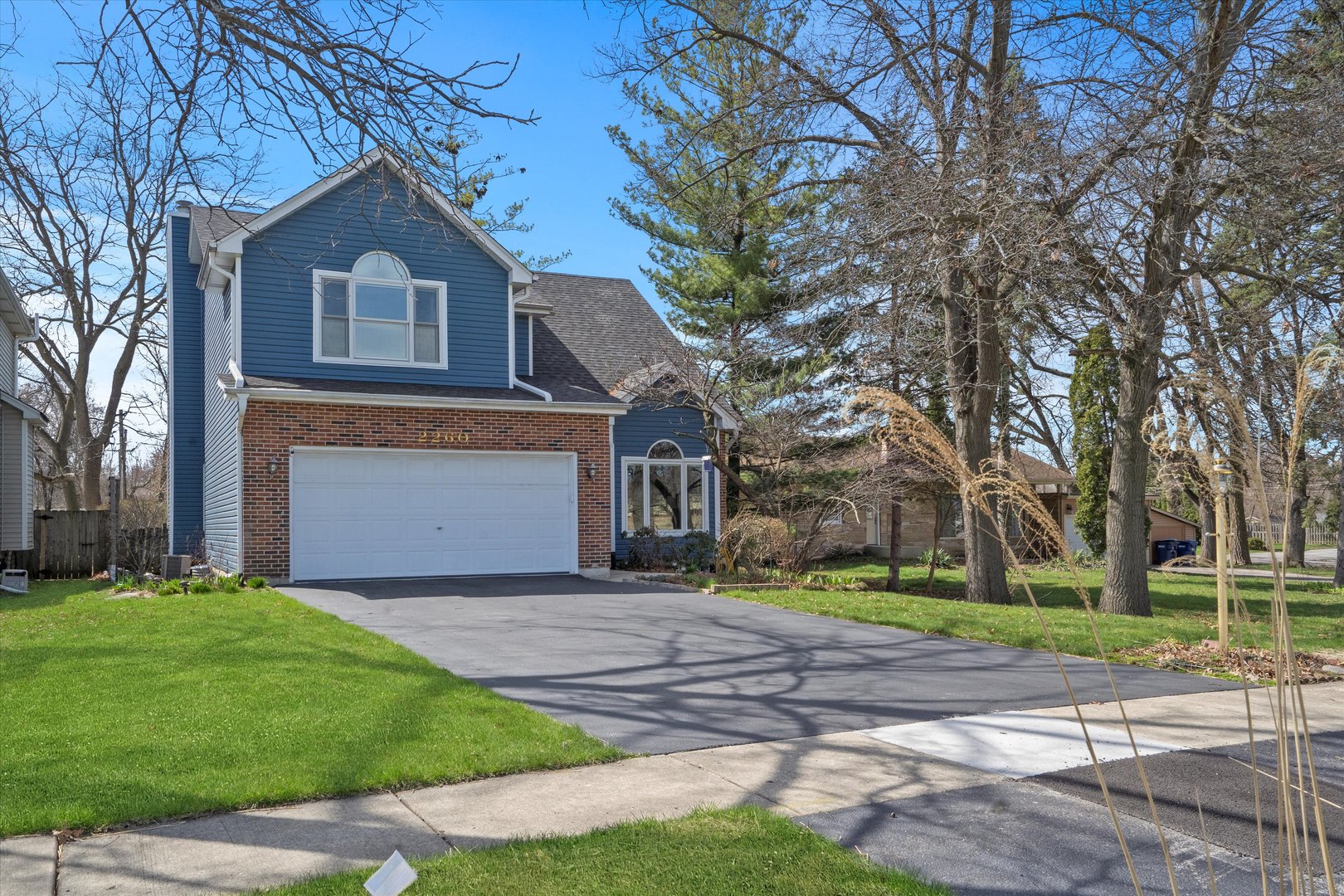 2260 Manchester Road Wheaton, IL 60187 - Photo 33 of 35 a front view of a house with a yard and garage