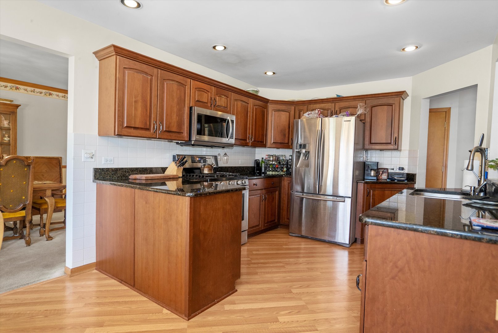2260 Manchester Road Wheaton, IL 60187 - Photo 9 of 35 a kitchen with granite countertop a refrigerator and a sink