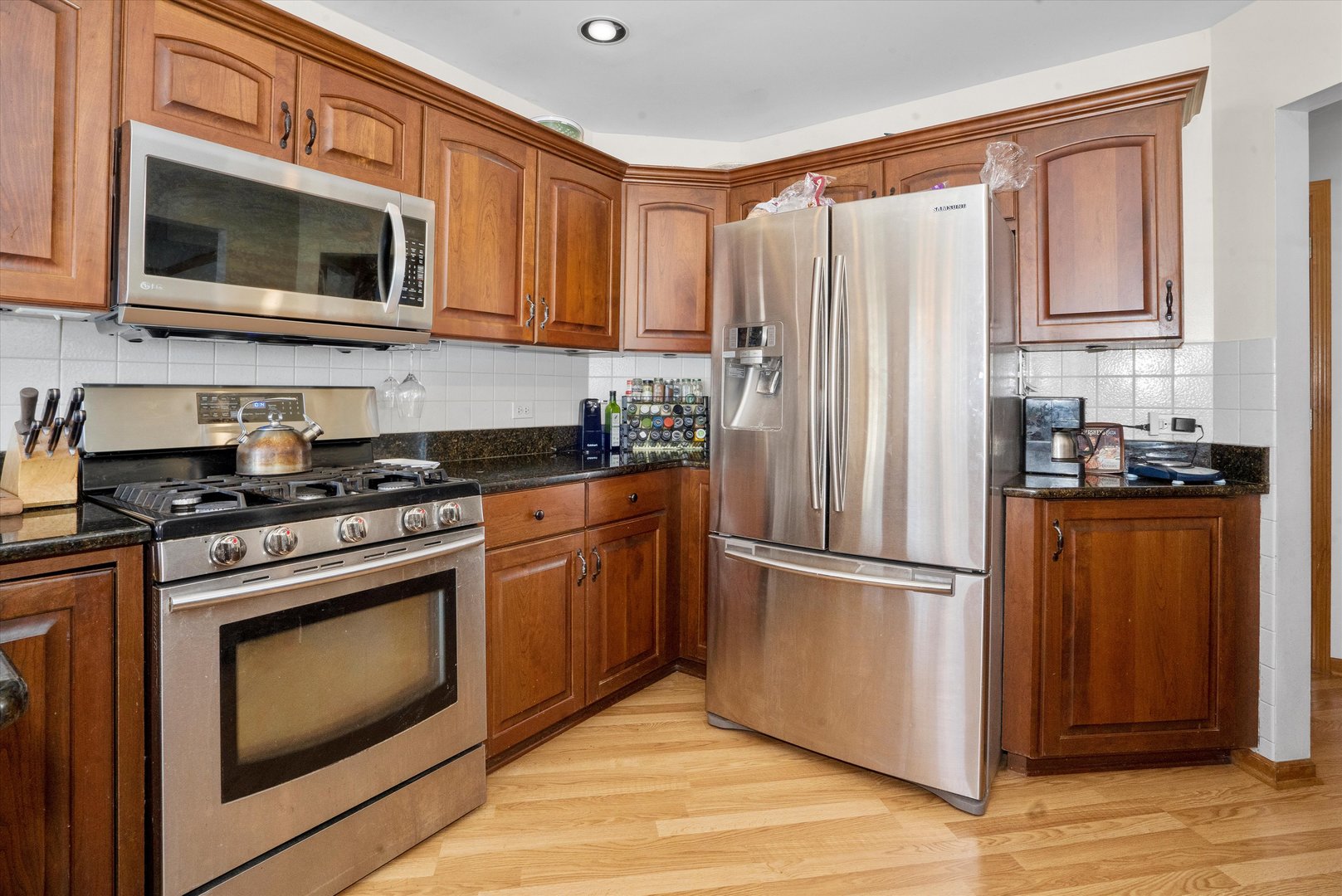 2260 Manchester Road Wheaton, IL 60187 - Photo 10 of 35 a kitchen with stainless steel appliances granite countertop a refrigerator stove and microwave