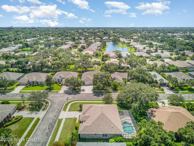 an aerial view of residential houses with outdoor space and swimming pool