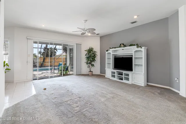 a view of livingroom with furniture flat screen tv and windows