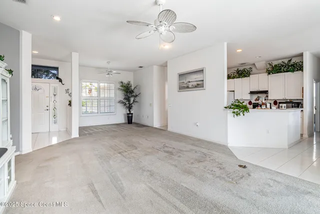 a view of a livingroom with furniture and a kitchen