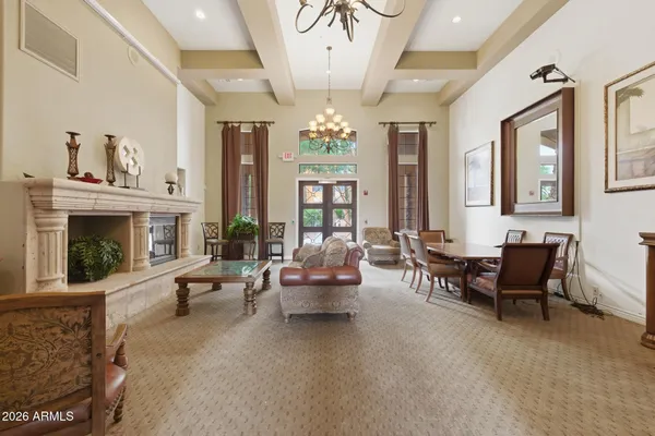 a living room with furniture a chandelier and a fireplace