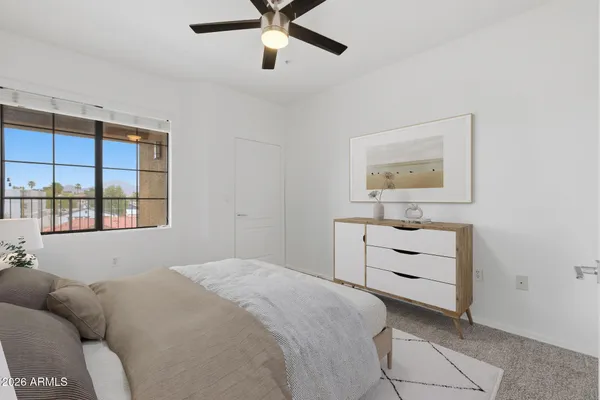 a bedroom with a bed and a window