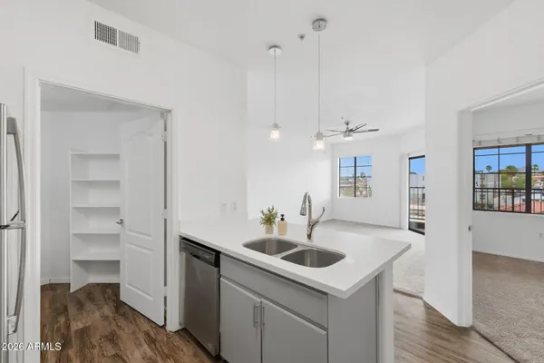 a kitchen with a sink cabinets and wooden floor