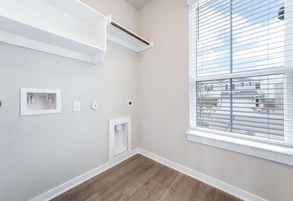 2221 Rocoso Trail Leander, TX 78641 - Photo 14 of 16 Laundry room featuring gas dryer hookup, hookup for a washing machine, electric dryer hookup, and wood finished floors