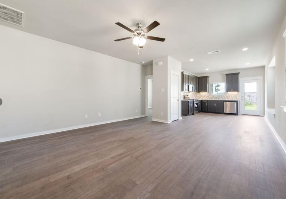 2221 Rocoso Trail Leander, TX 78641 - Photo 2 of 16 Unfurnished living room featuring dark wood-type flooring, ceiling fan, and recessed lighting