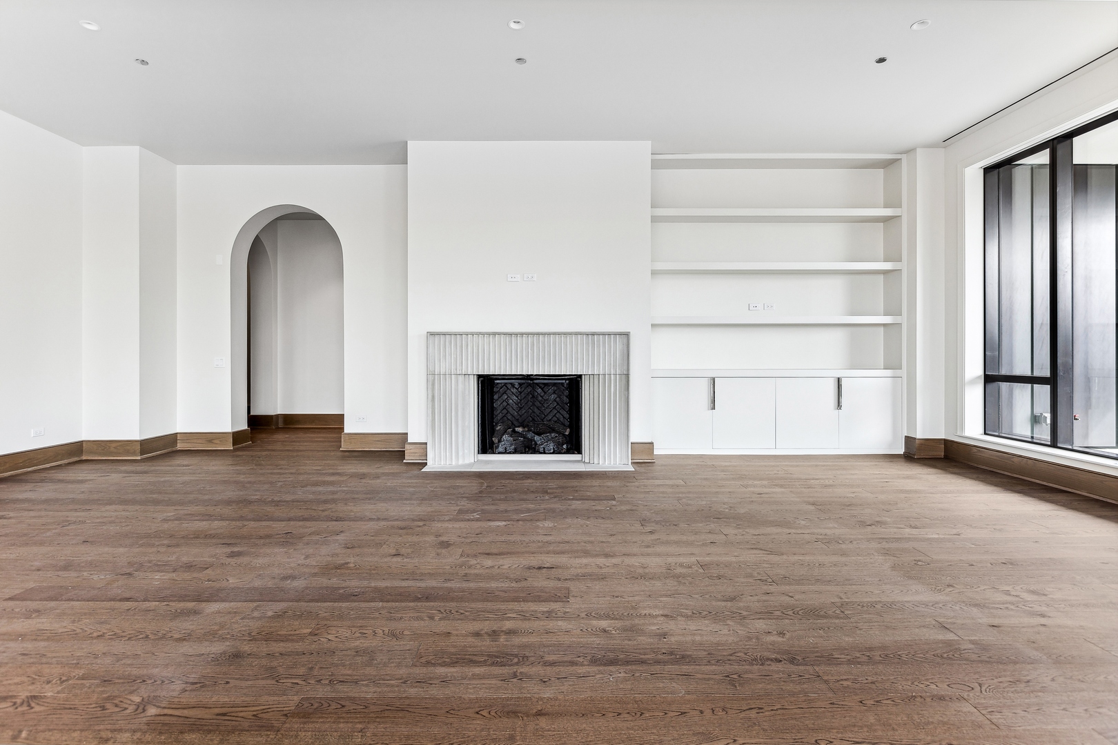 21 North May Street, Unit 601 Chicago, IL 60607 - Photo 12 of 64 a view of an empty room with a fireplace and a window
