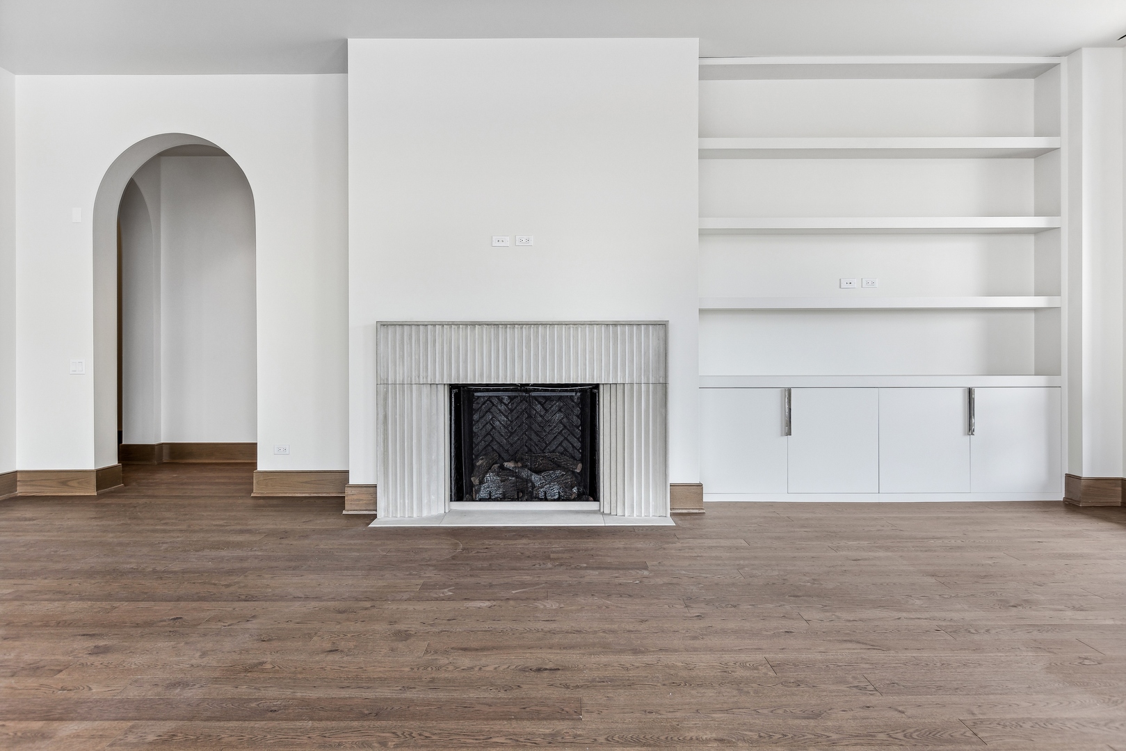 21 North May Street, Unit 601 Chicago, IL 60607 - Photo 13 of 64 a view of an empty room with wooden floor and a fireplace