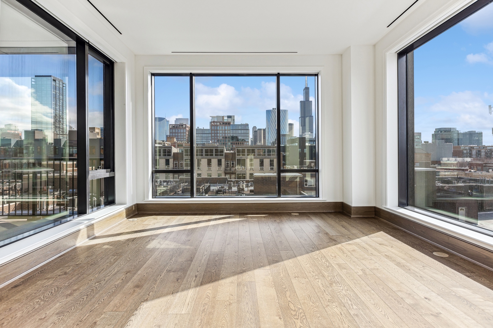 21 North May Street, Unit 601 Chicago, IL 60607 - Photo 21 of 64 a view of an empty room with wooden floor and a window