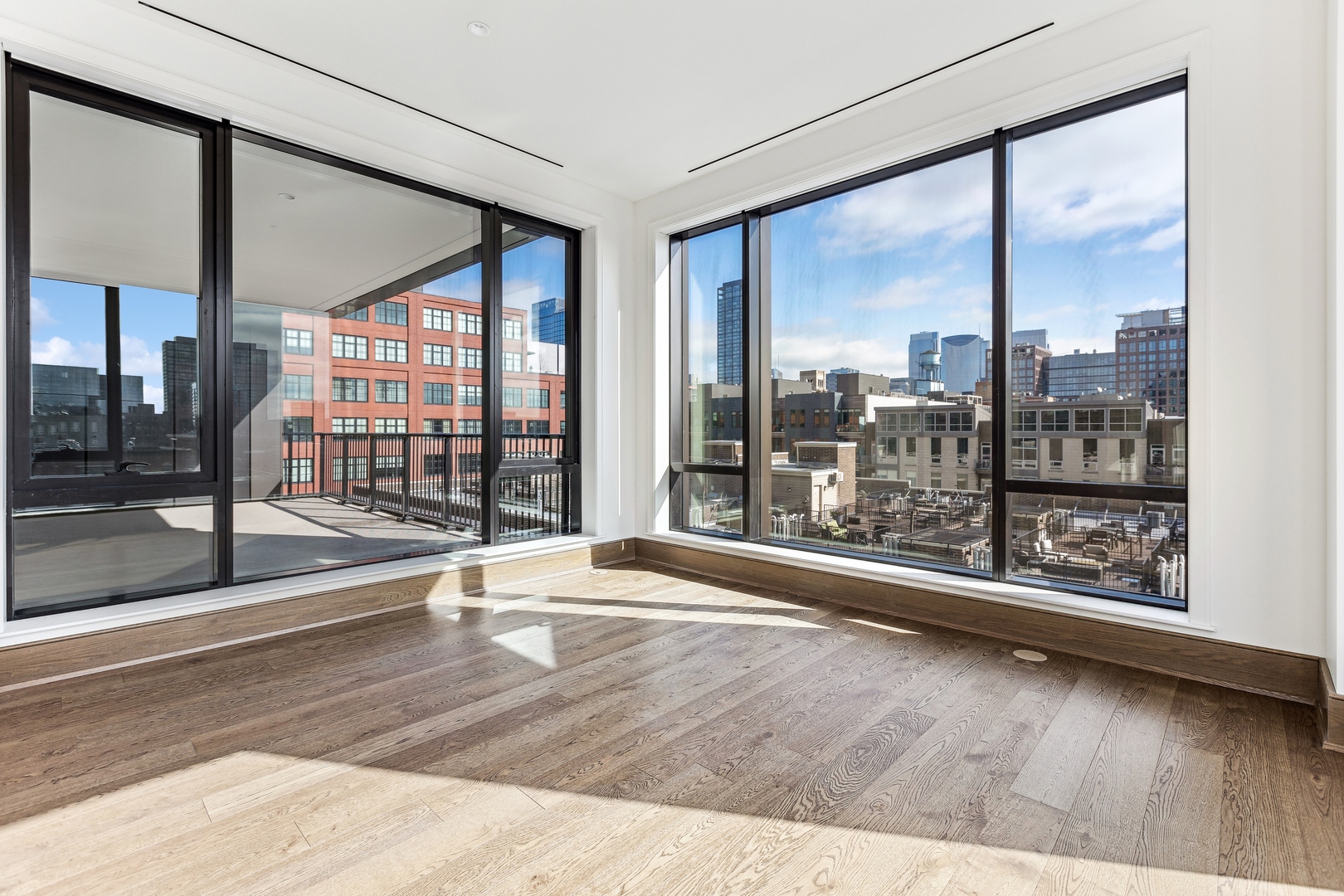 21 North May Street, Unit 601 Chicago, IL 60607 - Photo 22 of 64 a view of an empty room with wooden floor and a window