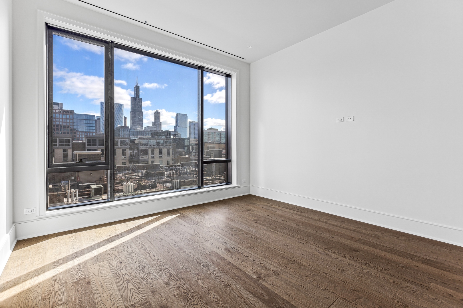 21 North May Street, Unit 601 Chicago, IL 60607 - Photo 40 of 64 a view of a room with wooden floor and a window