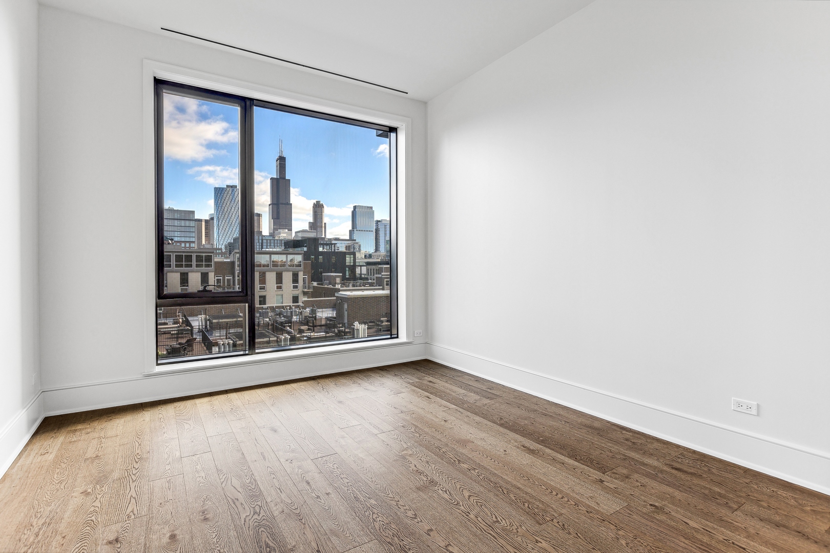21 North May Street, Unit 601 Chicago, IL 60607 - Photo 53 of 64 an empty room with wooden floor and windows