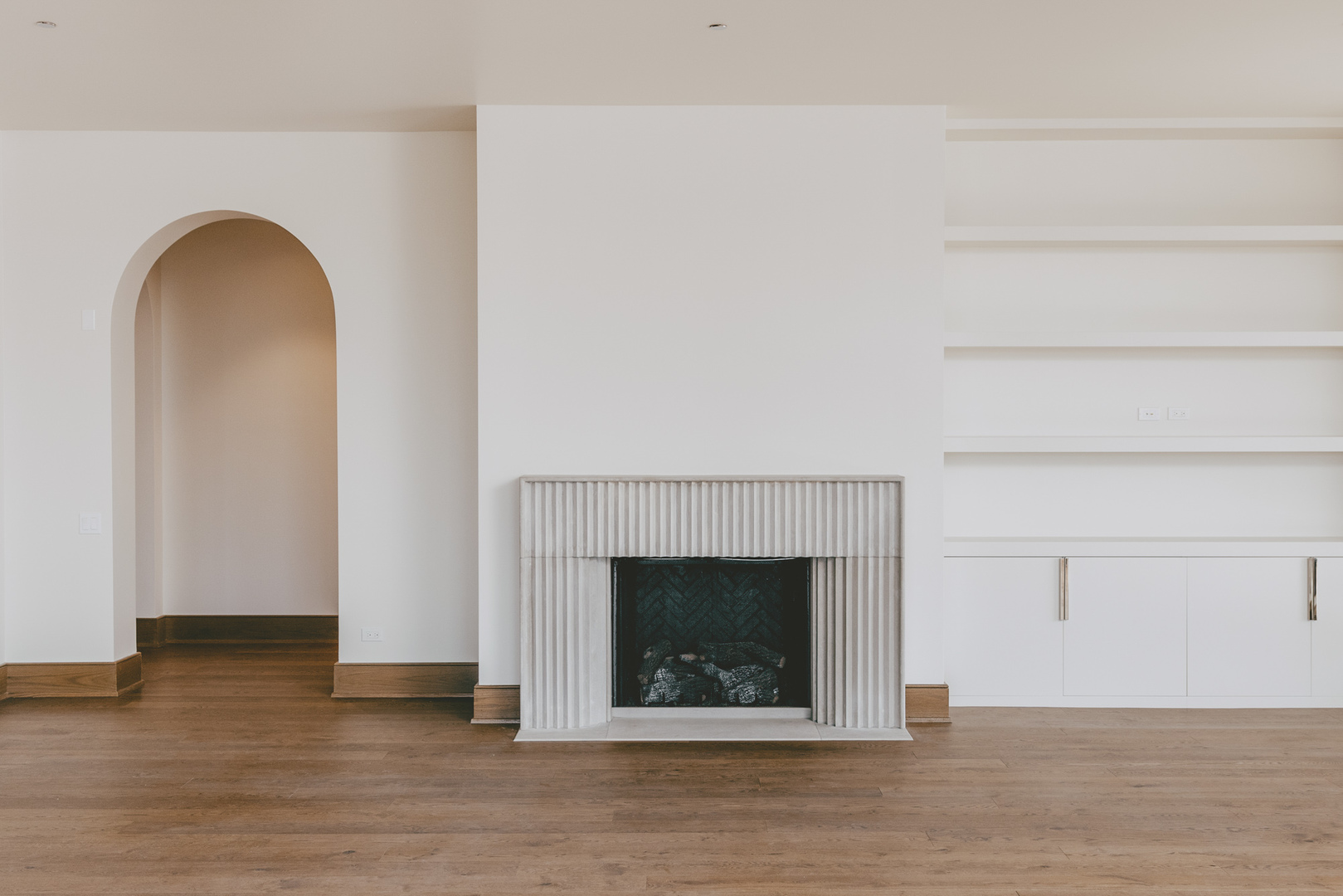 21 North May Street, Unit 601 Chicago, IL 60607 - Photo 7 of 64 a view of an empty room with wooden floor and a fireplace