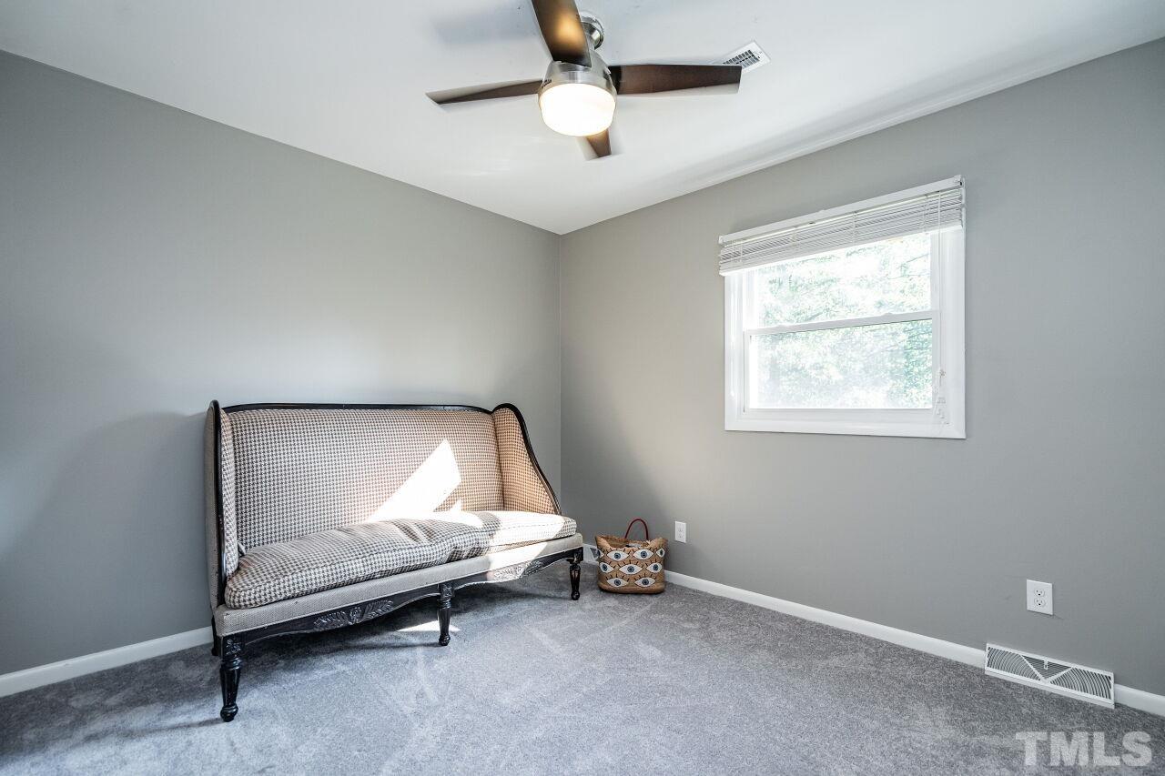 1500 Windbur Place Raleigh, NC 27609 - Photo 14 of 30 a bedroom with bed and a chandelier