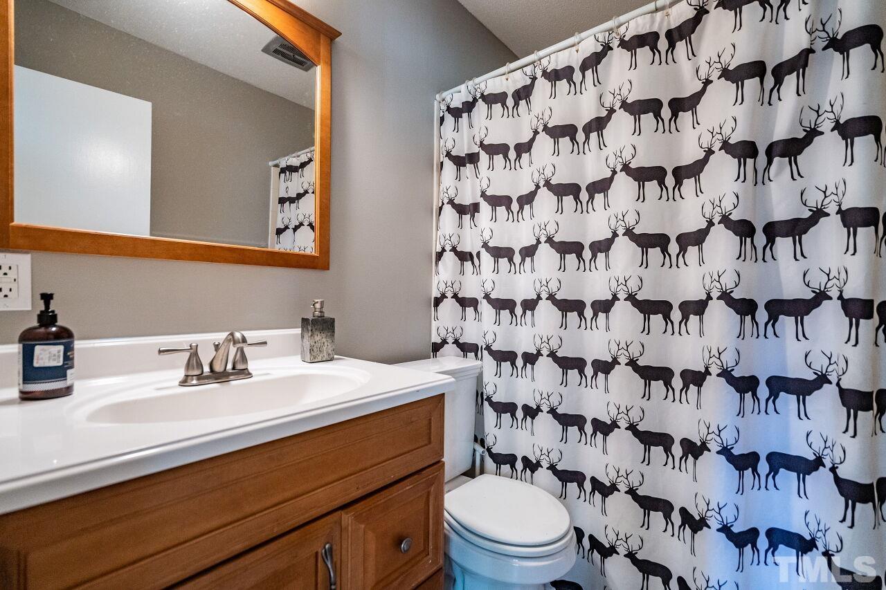 1500 Windbur Place Raleigh, NC 27609 - Photo 22 of 30 a bathroom with a sink toilet and shower