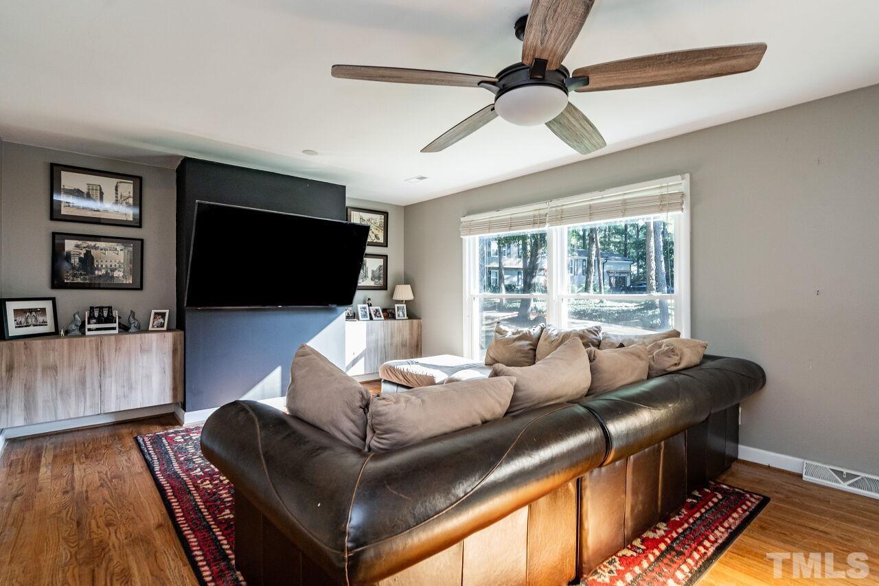 1500 Windbur Place Raleigh, NC 27609 - Photo 4 of 30 a living room with furniture and a flat screen tv