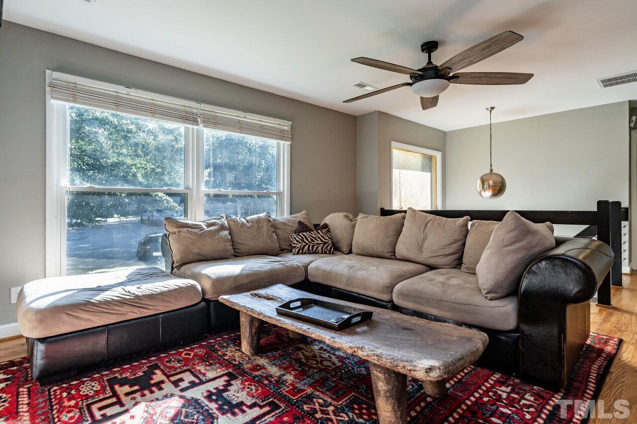 1500 Windbur Place Raleigh, NC 27609 - Photo 6 of 30 a living room with furniture and a large window