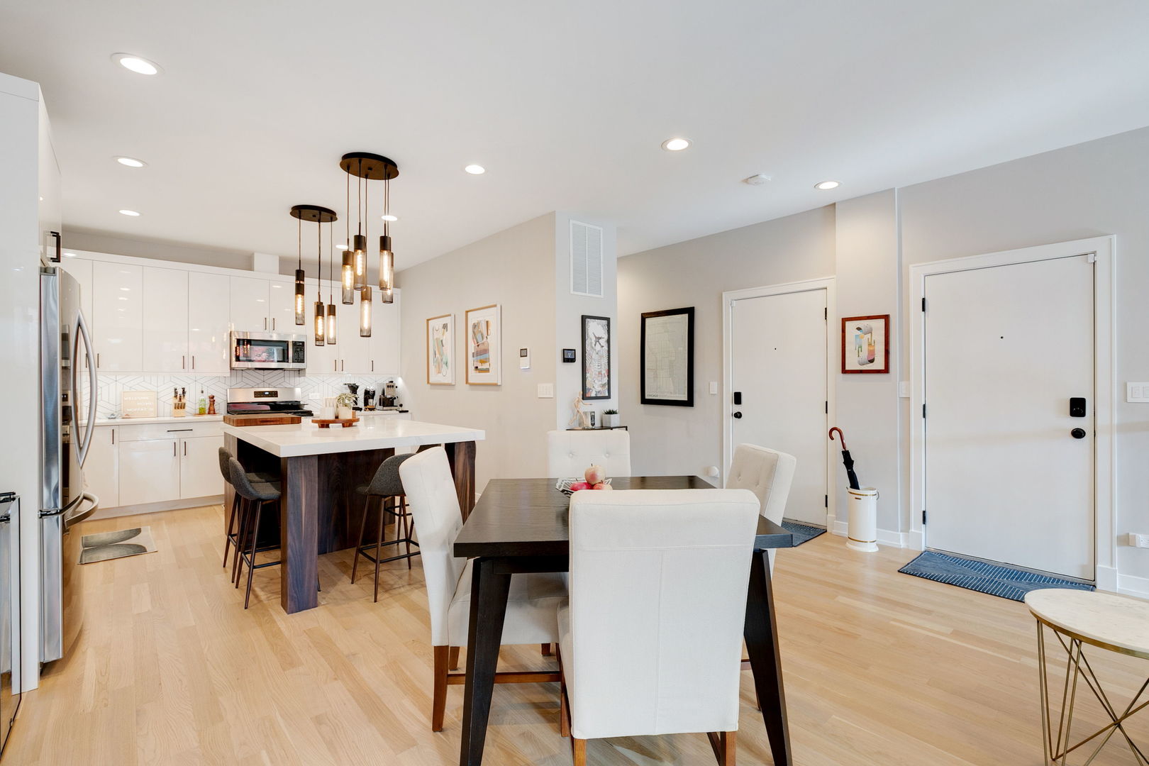 2404 West Moffat Street, Unit 1 Chicago, IL 60647 - Photo 18 of 41 a large kitchen with a table and chairs
