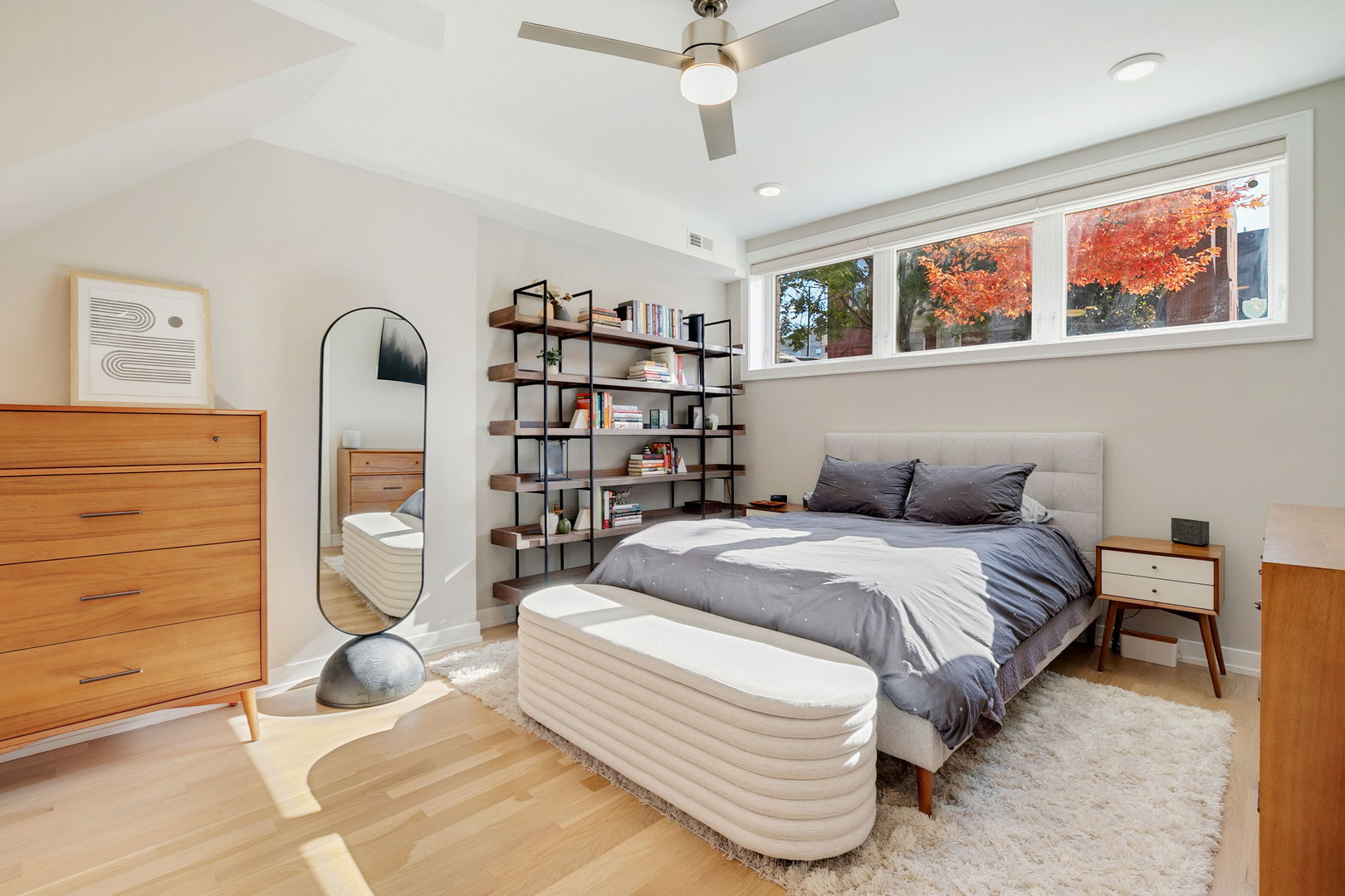 2404 West Moffat Street, Unit 1 Chicago, IL 60647 - Photo 22 of 41 a spacious bedroom with a bed a dresser and book shelf