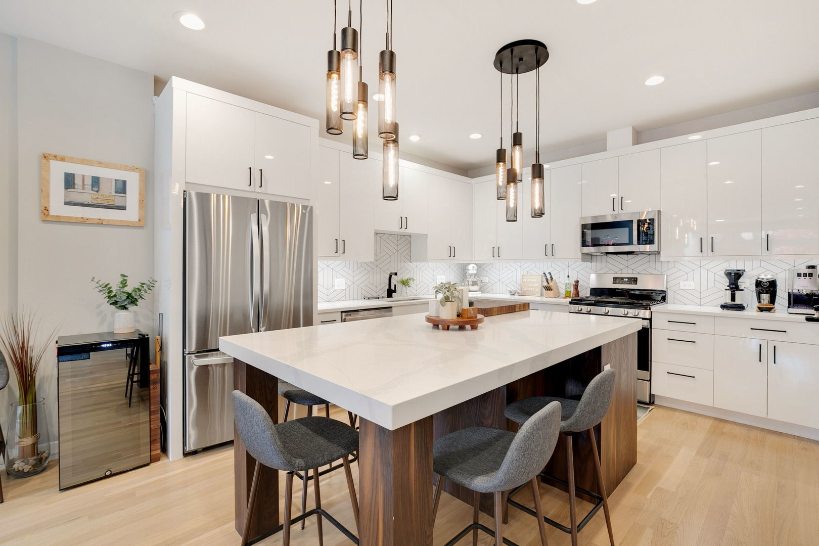 2404 West Moffat Street, Unit 1 Chicago, IL 60647 - Photo 10 of 41 a kitchen with stainless steel appliances kitchen island granite countertop a dining table and chairs