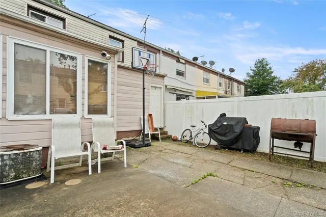 a front view of a house with outdoor seating