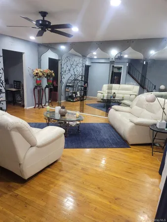 a living room with furniture and a pool table