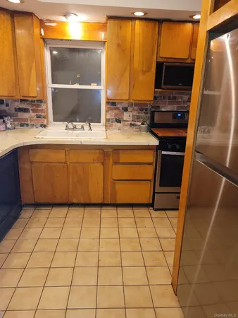 a kitchen with stainless steel appliances a sink and a refrigerator