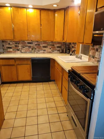 a kitchen with a sink a stove top oven and a counter top space