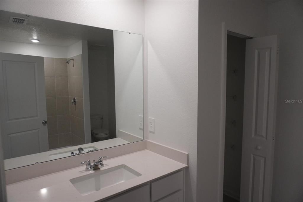 3779 Bergamot Boulevard Lake Alfred, FL 33850 - Photo 11 of 25 a bathroom with a sink and a mirror
