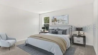 a bedroom with a bed and a couch