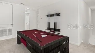 a room with pool table and a window