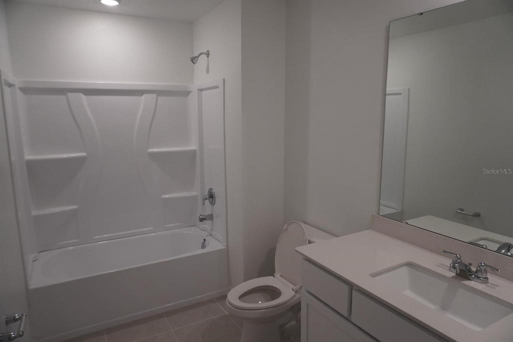 3779 Bergamot Boulevard Lake Alfred, FL 33850 - Photo 10 of 25 a bathroom with a sink a toilet and shower