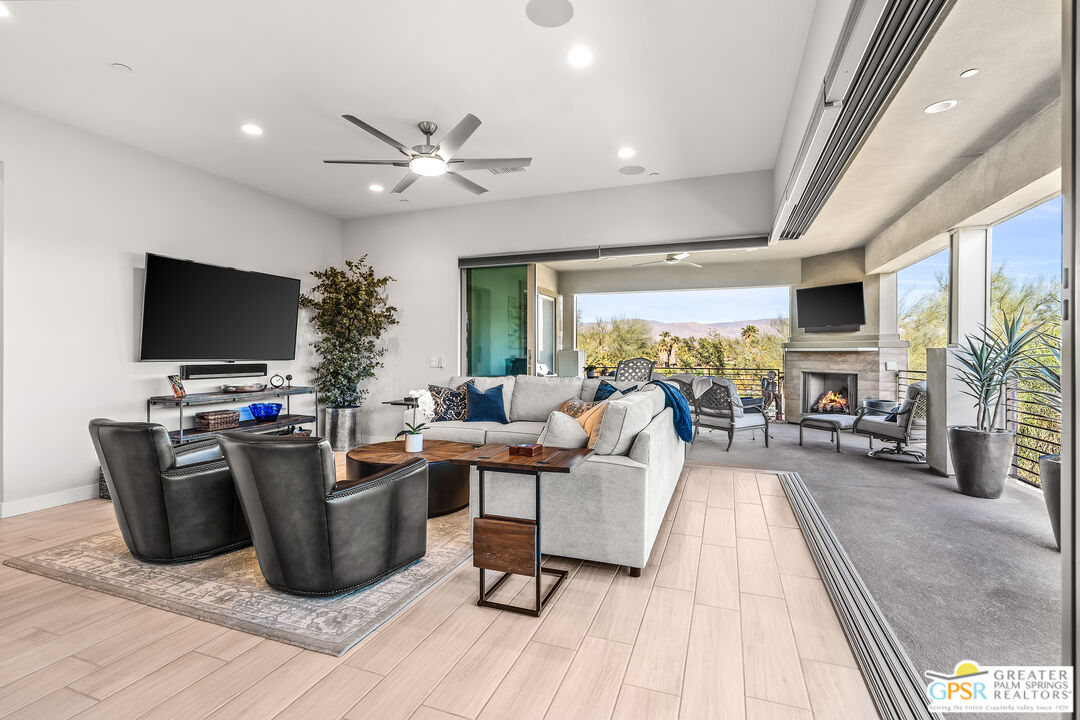 204 Retreat Circle Palm Desert, CA 92260 - Photo 1 of 60 a living room with furniture and a flat screen tv