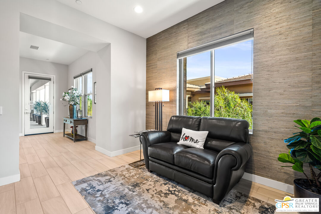 204 Retreat Circle Palm Desert, CA 92260 - Photo 13 of 60 a living room with furniture and a large window