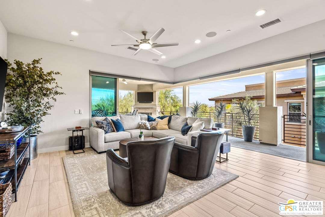 204 Retreat Circle Palm Desert, CA 92260 - Photo 17 of 60 a living room with furniture large window and wooden floor