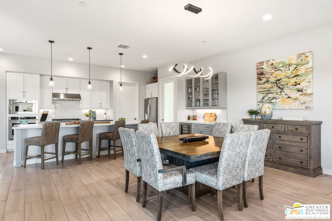 204 Retreat Circle Palm Desert, CA 92260 - Photo 23 of 60 a dining room with furniture and wooden floor