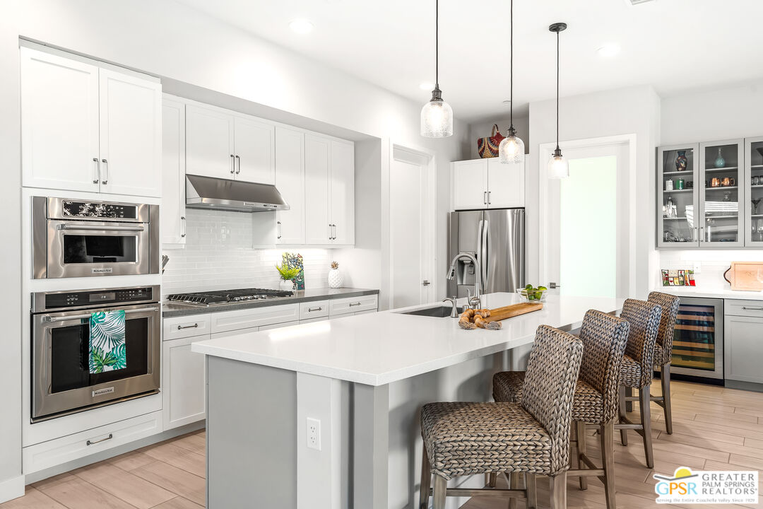 204 Retreat Circle Palm Desert, CA 92260 - Photo 26 of 60 a kitchen with stainless steel appliances a stove a sink and a refrigerator