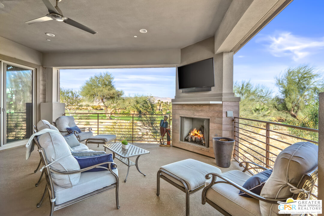 204 Retreat Circle Palm Desert, CA 92260 - Photo 3 of 60 a living room with furniture a fireplace and a flat screen tv