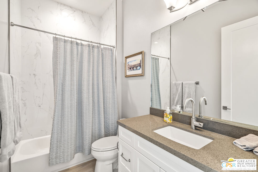 204 Retreat Circle Palm Desert, CA 92260 - Photo 32 of 60 a bathroom with a granite countertop sink and a mirror