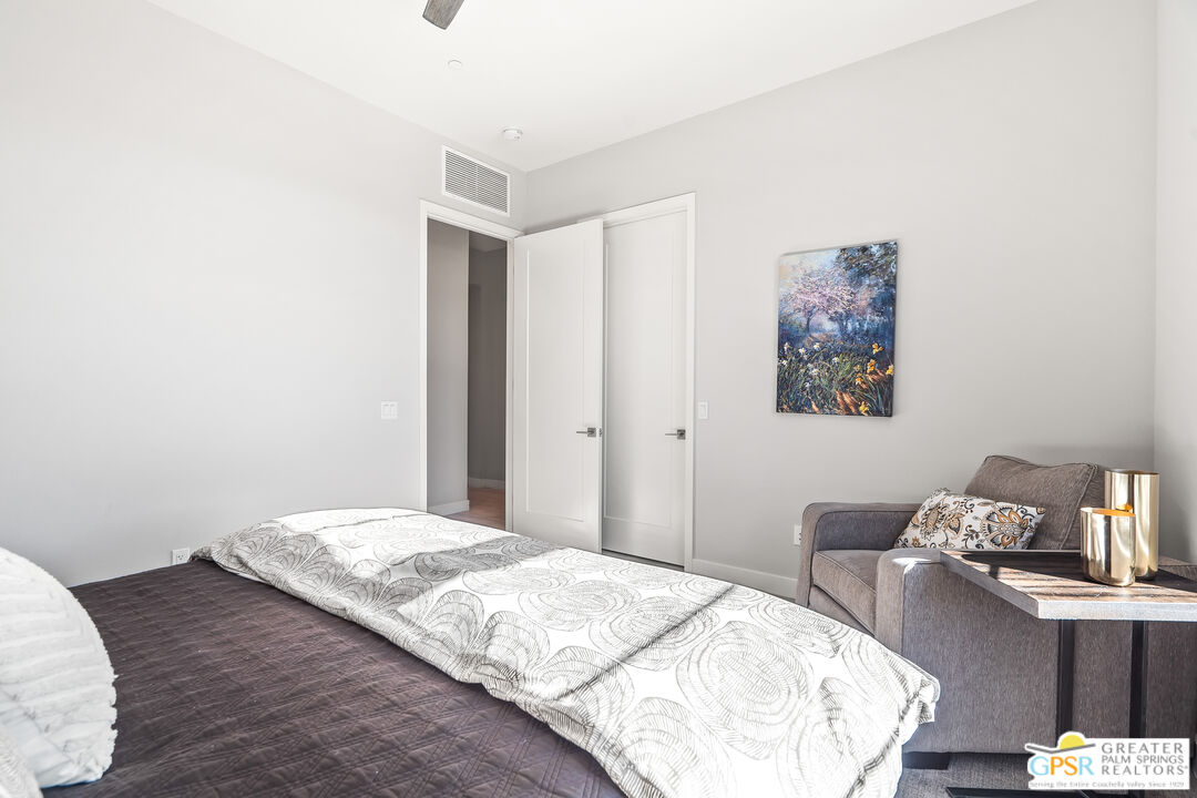 204 Retreat Circle Palm Desert, CA 92260 - Photo 34 of 60 a bedroom with a bed and a table in it