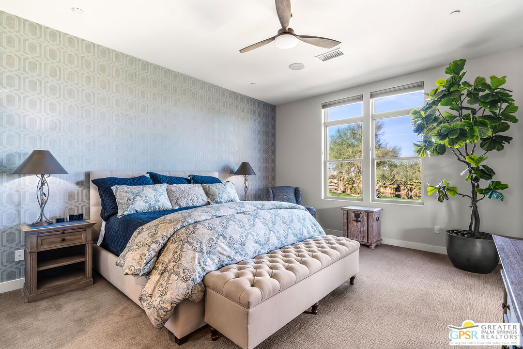 204 Retreat Circle Palm Desert, CA 92260 - Photo 35 of 60 a bedroom with a bed furniture a chandelier and a window