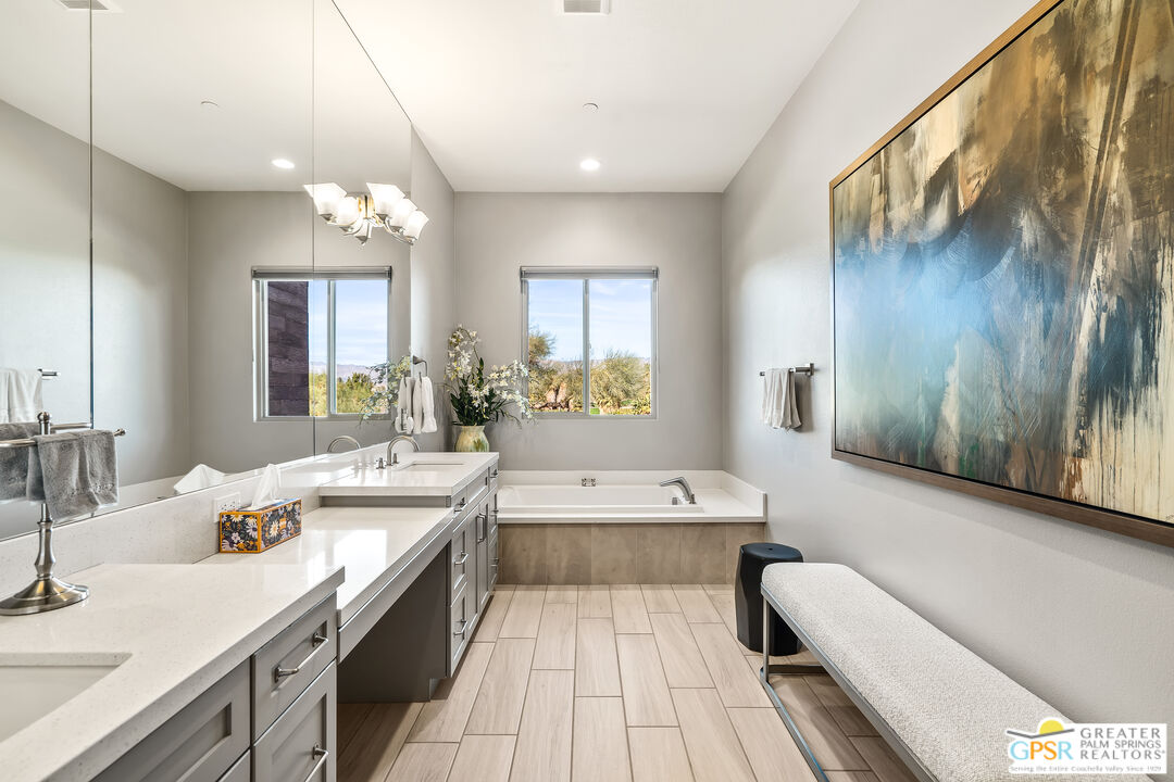 204 Retreat Circle Palm Desert, CA 92260 - Photo 39 of 60 a large bathroom with a double vanity sink a large mirror and a bathtub